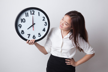 Young Asian woman with a clock.