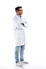 young doctor in white coat gesturing and looking at camera isolated on white