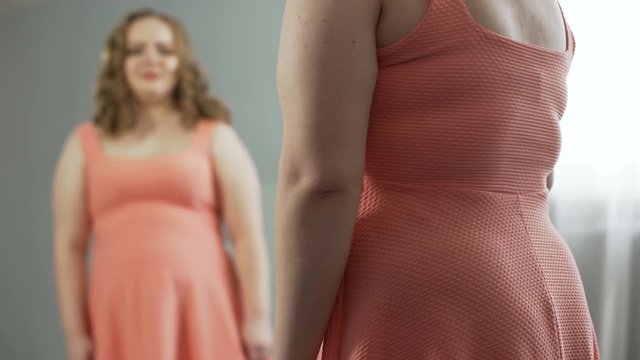Curved lady crying and blaming herself for eating too much and becoming fat