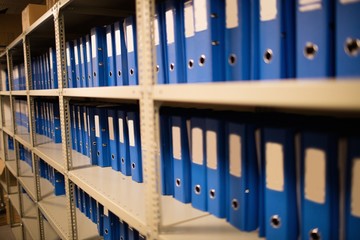 Blue files on shelves in storage room