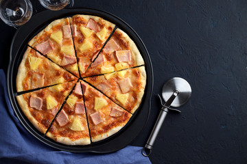 Homemade pizza hawaii with pineapple and ham on dark stone background. - 146039015