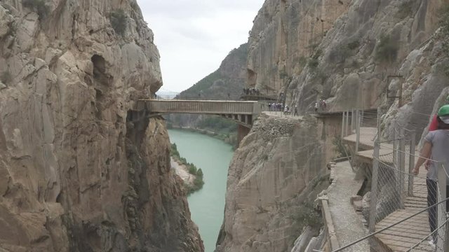 Walkers in 'El Caminito del Rey' with final bridge, route end