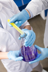 partial view of scientists making experiment in laboratory