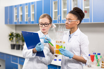 portrait of scientists working with test tubes, laboratory researcher concept