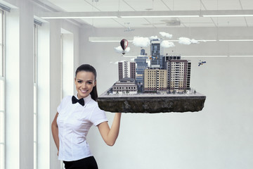 Obraz premium Woman presenting construction model. Mixed media