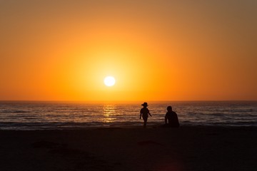 father and son at the sunset on the beach
