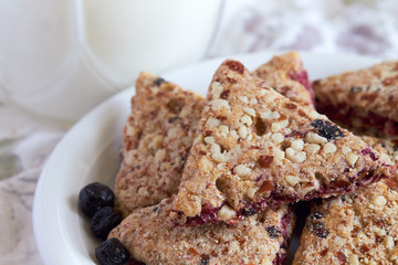 Integral cookies with aronia fruit served on white plate