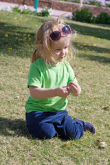 Fototapeta premium small baby boy with adorable face on green grass