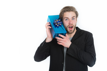 handsome happy businessman holding blue gift box