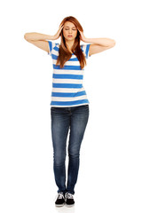Teenage woman with headache holding her hand to the head
