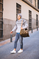 Confident and handsome young man in the street