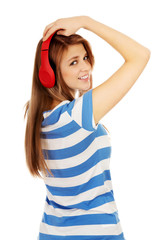 Obraz na płótnie Canvas Teenage woman listening to music
