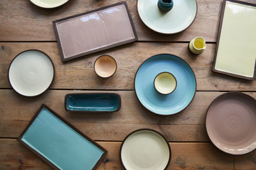 Overhead view of handmade earthenware arranged on wooden table