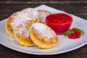 Cheese pancakes with honey in white plate.