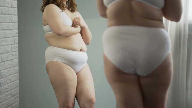 Sad girl embarrassed about her cellulite body and excess weight, health problem