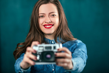 Young beautiful Girl with retro camera