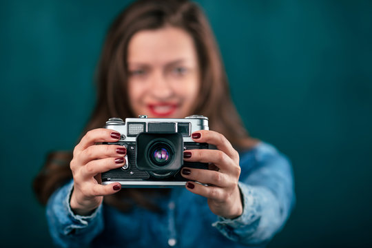 Young beautiful Girl with retro camera