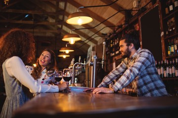 Young women interacting with each other at counter