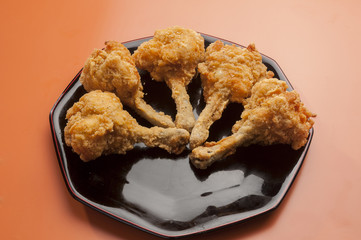 chicken lollypop on black plate