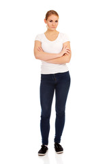 Fototapeta premium Worried young woman with folded arms