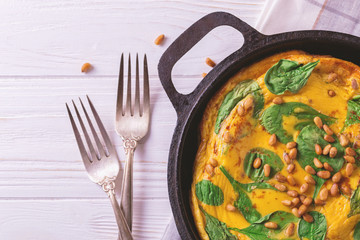 frittata with eggs, spinach, cheese and pine nuts