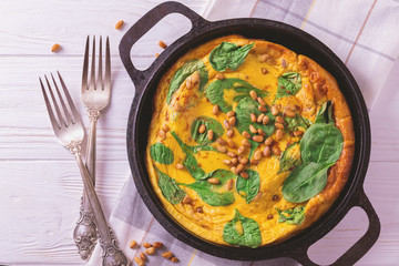 frittata with eggs, spinach, cheese and pine nuts