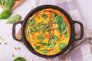 frittata with eggs, spinach, cheese and pine nuts