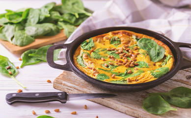 frittata with eggs, spinach, cheese and pine nuts