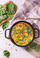 frittata with eggs, spinach, cheese and pine nuts