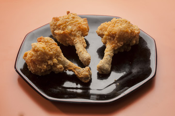 Chicken lollypop on black plate