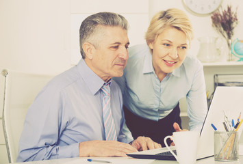 Colleagues look interesting in computer