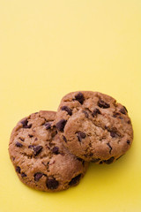 Chocolate chip cookies on yellow background
