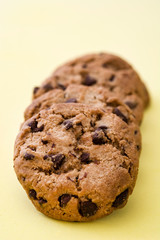 Chocolate chip cookies on yellow background
