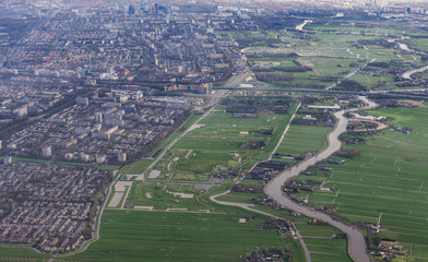 Beautiful view through airplane window, airplane flying above city.