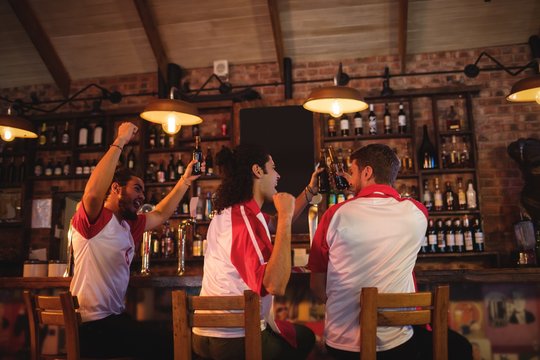 Group Of Male Friends Watching Football Match