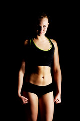 Fototapeta na wymiar Young athletic woman in black sports underwear