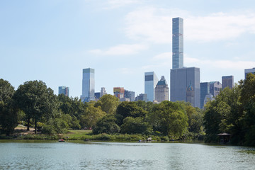 Fototapeta na wymiar New York city skyline with 432 Park Avenue skyscraper from Central Park with pond view