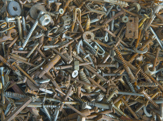 Sun shining through workshop window on assorted nuts bolts and screws