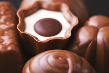 Horizontal close-up shot of sweet chocolate candy with white stuffing.