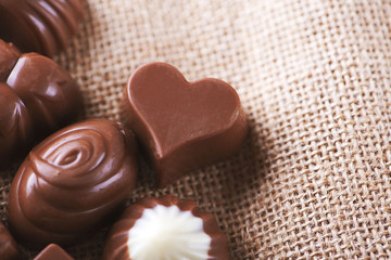 Chocolate bonbons on brown cloth.