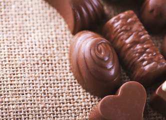 Horizontal close-up shot of chocolates and sweets placed on the canvas.
