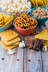 Unhealthy snacks on wooden background