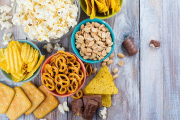 Unhealthy snacks on wooden background