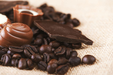 Coffee and dark chocolate placed on canvas. Horizontal shoot.