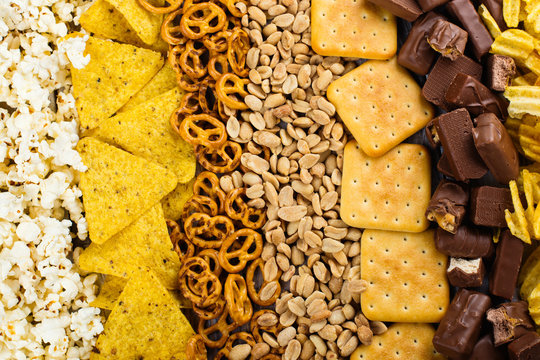 Unhealthy snacks on wooden background