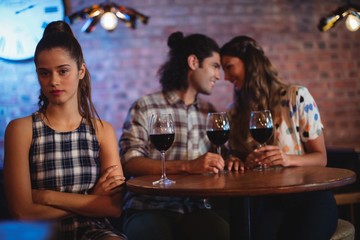 Jealous woman ignoring affectionate couple 