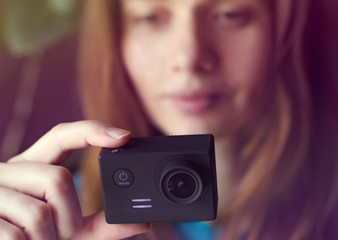 Woman hand holding action camera