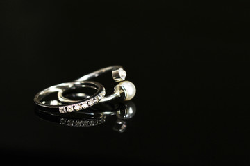 Beautiful wedding rings on a black glossy surface