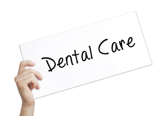 Dental Care Sign on white paper. Man Hand Holding Paper with text. Isolated on white background