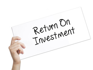 Return On Investment  Sign on white paper. Man Hand Holding Paper with text. Isolated on white background